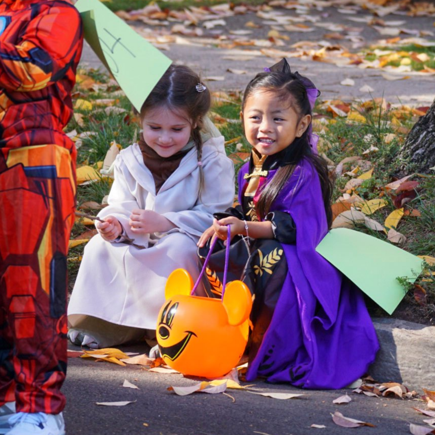 girls on curb in halloween costumes